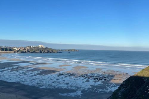 a view of a beach with the ocean and houses at The Lounge in Newquay