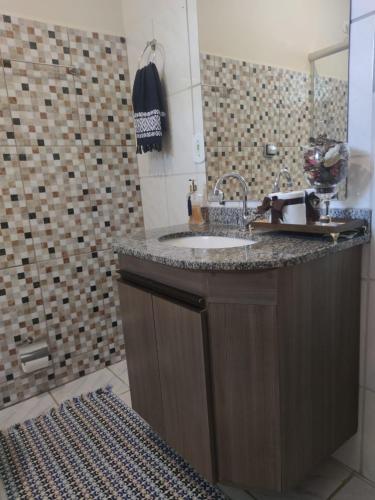 a bathroom with a sink and a shower at Pousada Rancho Bonito in Bonito