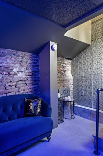 a blue couch in a room with a brick wall at The Wesley Walla Walla in Walla Walla