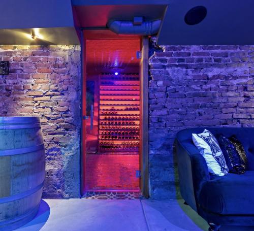 a room with a brick wall and a door with red lights at The Wesley Walla Walla in Walla Walla