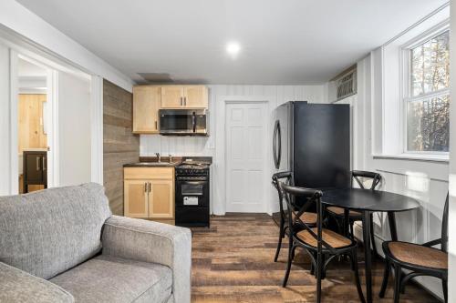 a kitchen with a couch and a table and a refrigerator at The Inn & More in Bartlett