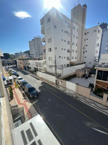 a view of a city street with buildings and a car at Pousada Louise in Balneário Camboriú