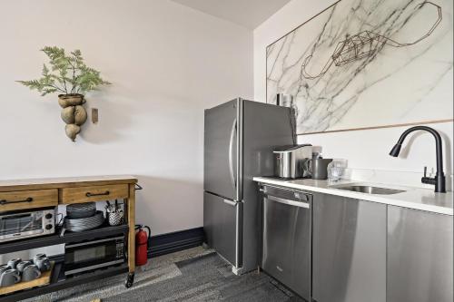 a kitchen with a stainless steel refrigerator and a sink at The Wesley Walla Walla in Walla Walla
