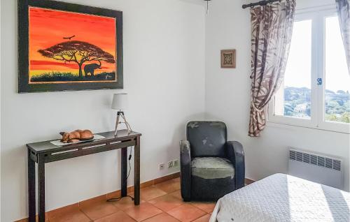 a bedroom with a desk and a chair and a window at Mas Des Oliviers in Cavalaire-sur-Mer