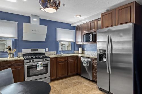 a kitchen with wooden cabinets and stainless steel appliances at The Wesley Walla Walla in Walla Walla