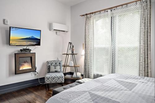 a white bedroom with a bed and a fireplace at The Wesley Walla Walla in Walla Walla