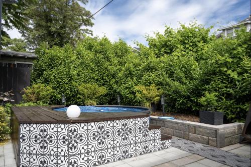a pool in a garden with a white and black pattern at The Wesley Walla Walla in Walla Walla