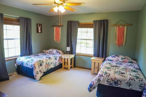 a bedroom with two beds and two windows at Steve's Sweet Spot - UP Adventure Getaway in Silver City
