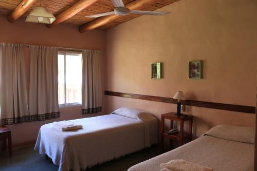 蒂爾卡拉的住宿－Hotel Punta Corral，酒店客房设有两张床和窗户。