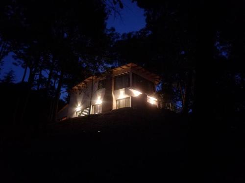 a house lit up at night with lights on it at Villa Fantasía a 15 min a pie de cascada in Mazamitla
