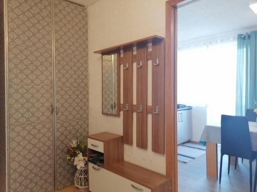 a room with a walk in shower and a dining room at Apartments Zupan in Šenčur