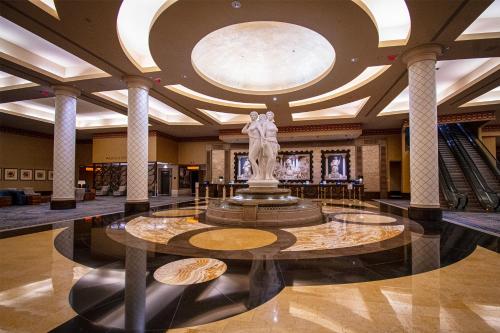 a lobby with a statue in the center of a building at Caesars Windsor Hotel and Casino in Windsor