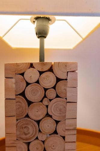 a light hanging from a ceiling with a wood cut out at Casas de Campo do Castro da Cola in Marchicão