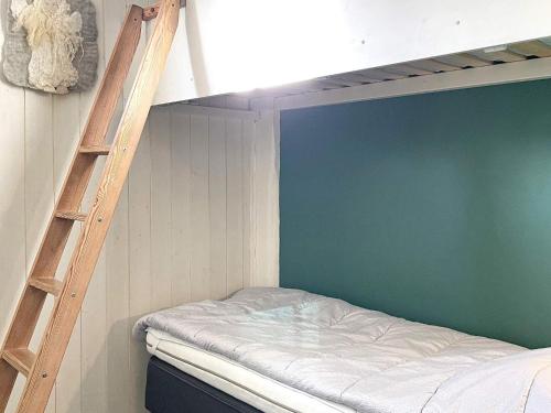 a bunk bed in a room with a ladder at 9 person holiday home in LIDKÖPING-By Traum in Lidköping