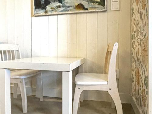 a white table and chair with a white table and chairs at 9 person holiday home in LIDKÖPING-By Traum in Lidköping