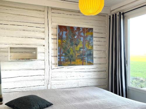 a bedroom with a wall with a painting and a bed at 9 person holiday home in LIDKÖPING-By Traum in Lidköping