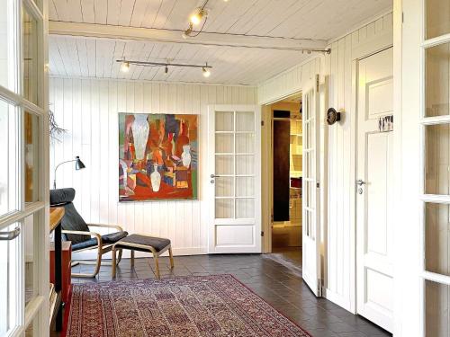 a hallway with a table and a painting on the wall at Holiday home LIDKÖPING VIII in Lidköping