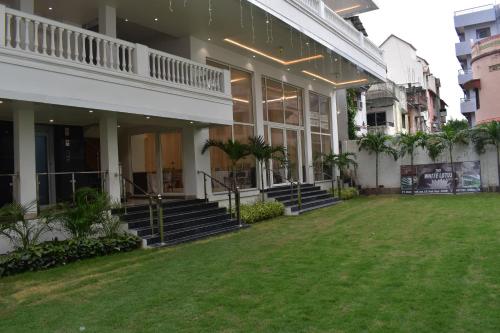 a building with a lawn in front of it at The White Lotus in Gaya