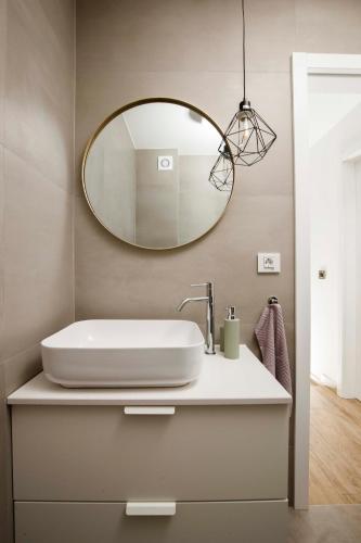 a bathroom with a sink and a mirror at Bura house in Pag