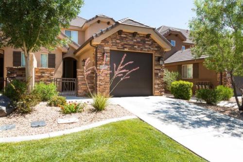 a house with a garage door in a yard at Cactus Rose Villa with 2 Pools 2 Spas Gym in Washington