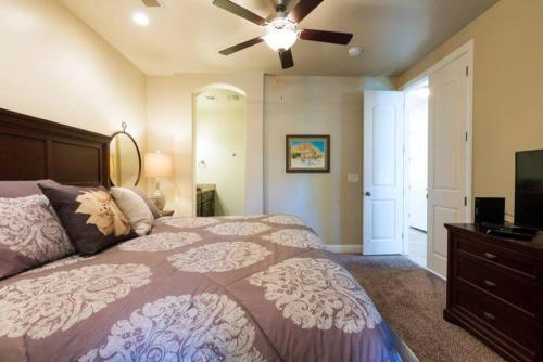 a bedroom with a bed and a ceiling fan at Cactus Rose Villa with 2 Pools 2 Spas Gym in Washington