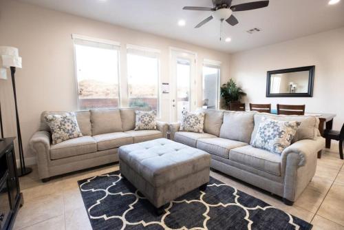 a living room with two couches and a ceiling fan at Coral Ridge Oasis 30 Mins From Zion NP 2 Pools in Washington