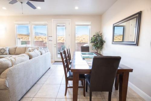 a living room with a table and a couch at Coral Ridge Oasis 30 Mins From Zion NP 2 Pools in Washington