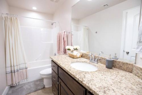 a bathroom with a sink and a toilet at Coral Ridge Oasis 30 Mins From Zion NP 2 Pools in Washington