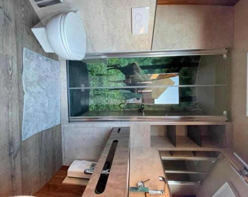 a kitchen with a sink and a mirror at Schlafen im Weinfass in Ipsheim