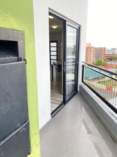 a balcony of a building with a view of a table at DMN City at Merensky Apartment in Windhoek
