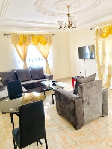a living room with a couch and a table at APEX ANNEX Guest Facility in Buea