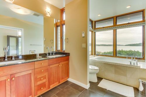 a bathroom with a tub and a sink and a toilet at Fidalgo Island Waterfront Stunner in Anacortes