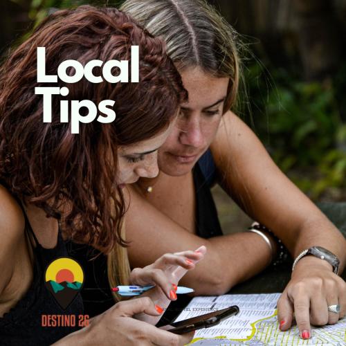 two young women looking at a cell phone at Destino26 Hostel in Montevideo