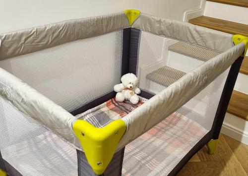 a teddy bear sitting in the inside of a baby crib at Podlaski Zakątek in Bereżyszcze