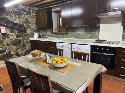 a kitchen with a table with a bowl of fruit on it at Archontiko Rousias in Nicosia