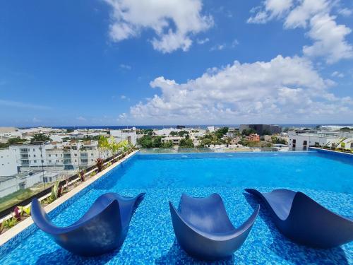 a swimming pool with a view of a city at Modernos Estudios a pasos De La 5ta Av Pool view - By Yeah in Playa del Carmen