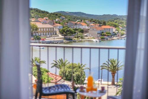 a view of a river from a room with a balcony at Hotel Lumbarda in Lumbarda