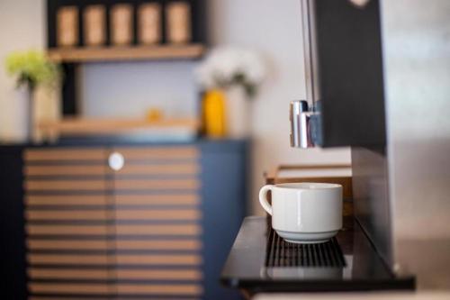 a coffee cup sitting on top of a table at Hotel Lumbarda in Lumbarda