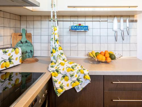 a kitchen with a counter with a bowl of fruit at Euphoria Country House in Agios Ioannis