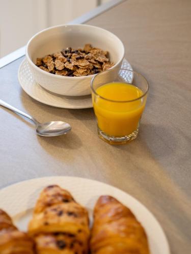 a plate of pastries and a glass of orange juice at Euphoria Country House in Agios Ioannis