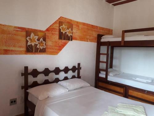 a bedroom with two beds and a bunk bed at Nova Pousada Sollaris - Coração da Serra do Cipó - MG in Santana do Riacho