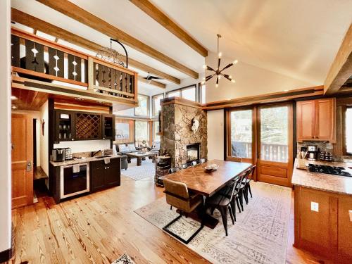 a kitchen with a wooden table and a dining room at Highland Huckleberry Lodge in Whitefish