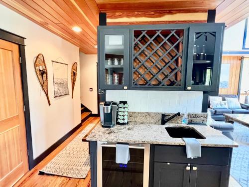 a kitchen with a counter and a wine cellar at Highland Huckleberry Lodge in Whitefish