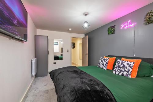 a bedroom with a large bed and a tv at NEW Luxury Smart Cinema Stylish Apartment in Bradford