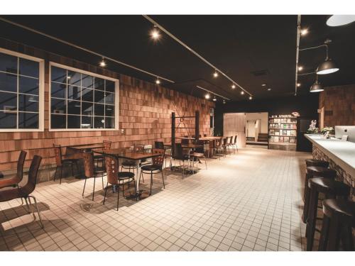 a restaurant with tables and chairs in a room at Noboribetsu Guest House AKA and AO - Vacation STAY 20484v in Noboribetsu