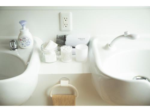 a bathroom with a sink and a toilet and a sink at Noboribetsu Guest House AKA and AO - Vacation STAY 20484v in Noboribetsu