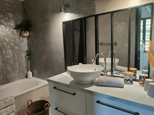 a bathroom with a sink and a bath tub and a sink at Gite de la tannerie 3 in Dinan