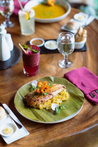 Una mesa de madera con un plato de comida encima. en Trogon Lodge, en San Gerardo de Dota