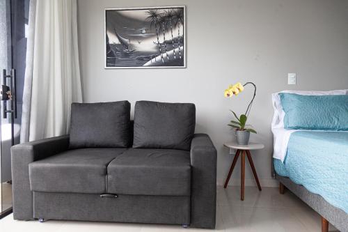 a living room with a couch and a chair at Pousada Guaricana in Pontal do Paraná