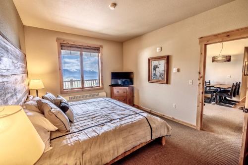 a bedroom with a bed and a window at Morning Eagle 411 in Whitefish